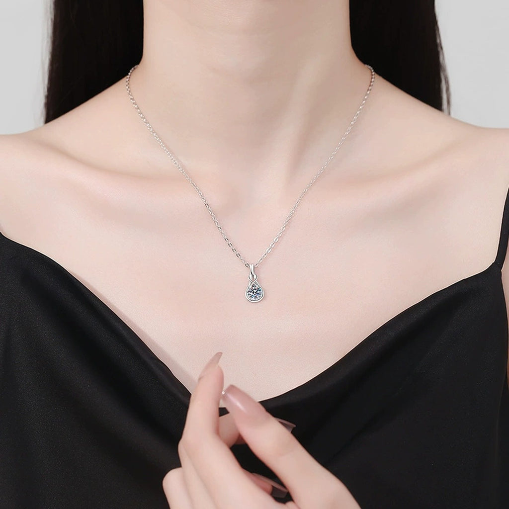 Teardrop Twist Moissanite Pendant Necklace in Platinum-Plated S925 Sterling Silver worn on neckline by model
