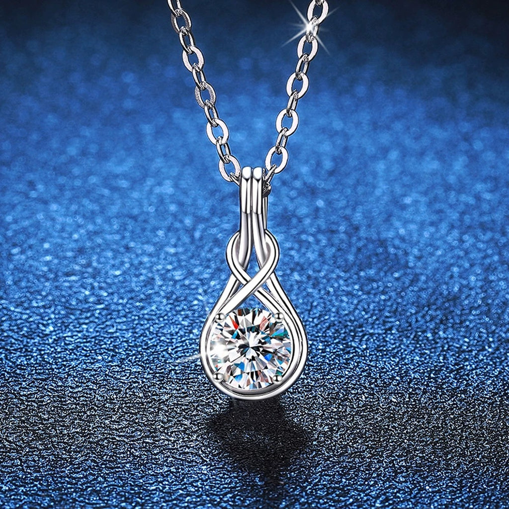 Teardrop Twist Moissanite Pendant Necklace in Platinum-Plated S925 Sterling Silver blue background angled view
