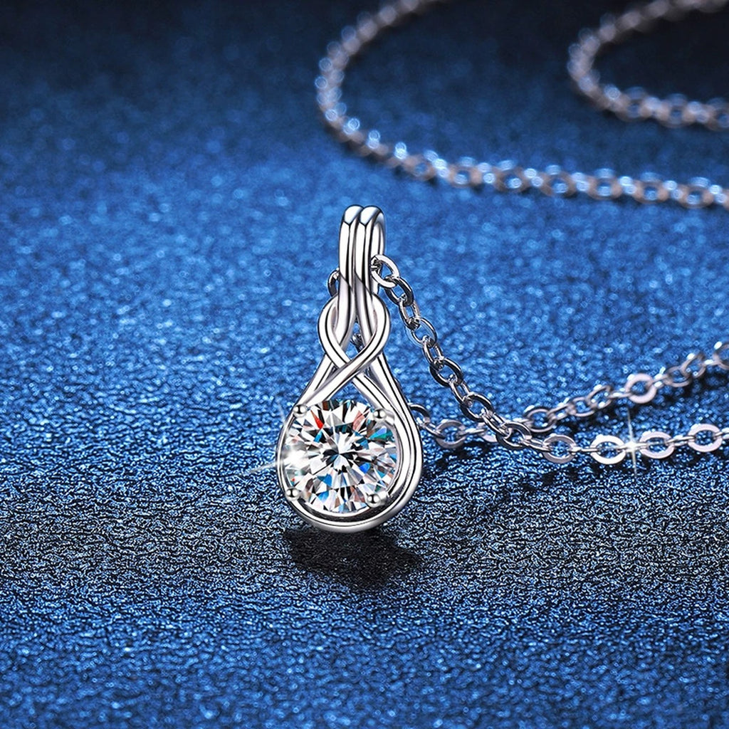 Teardrop Twist Moissanite Pendant Necklace in Platinum-Plated S925 Sterling Silver blue background close-up view