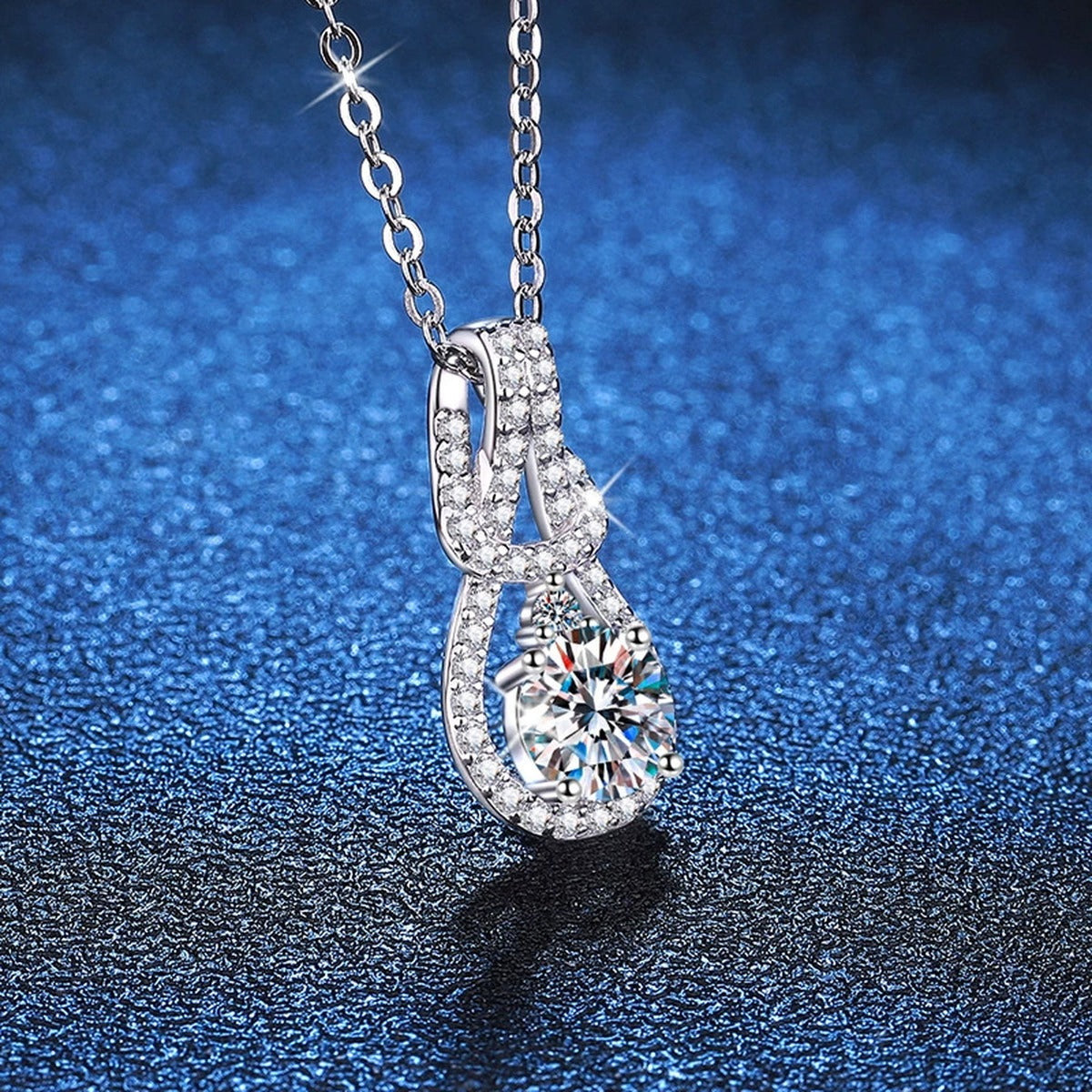 Pave Teardrop Moissanite Pendant Necklace in Platinum-Plated S925 Sterling Silver blue background angled view