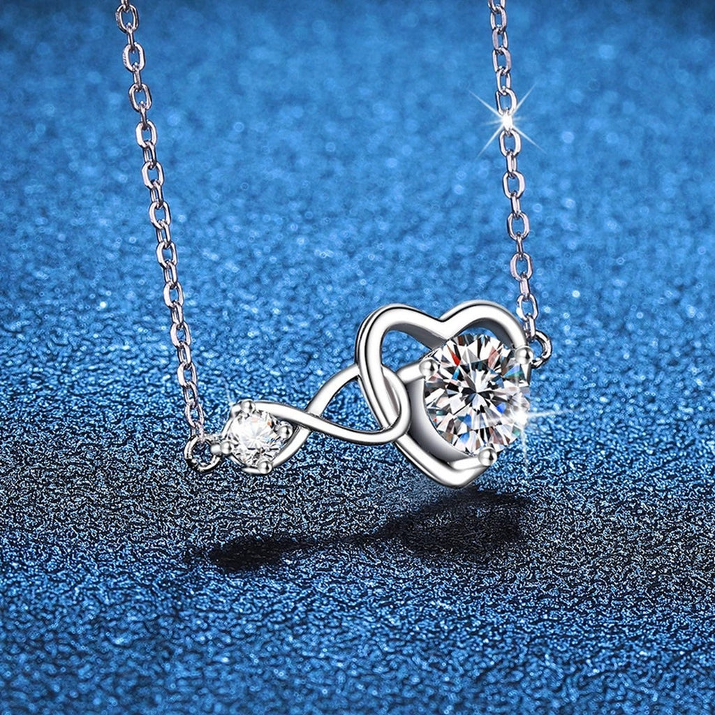 Infinity Heart Moissanite Station Necklace in Platinum-Plated S925 Sterling Silver blue background angled view
