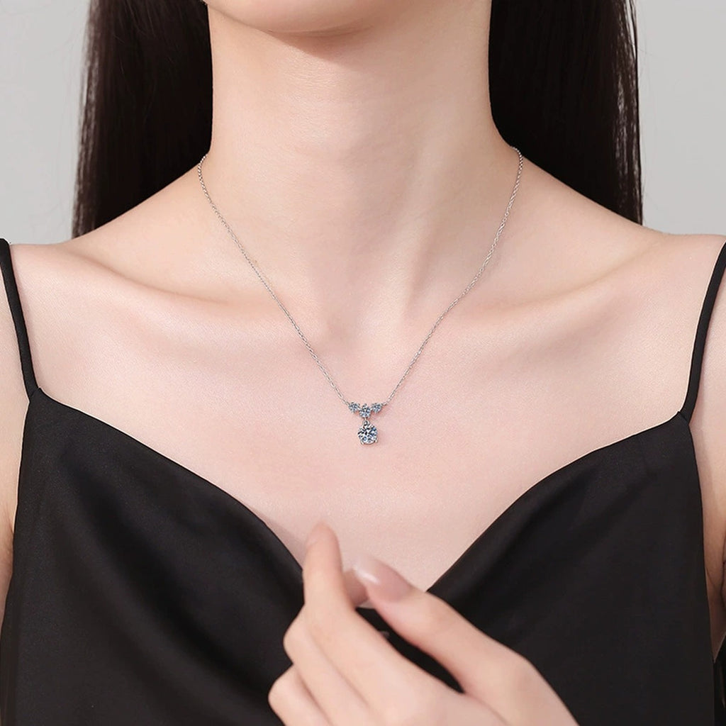 Bow Drop Moissanite Pendant Necklace in Platinum-Plated S925 Sterling Silver worn on neckline by model