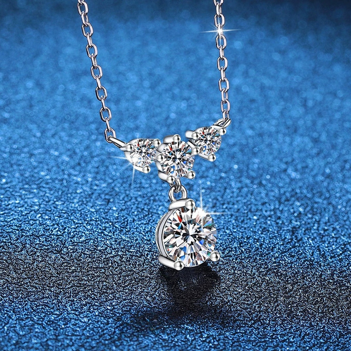 Bow Drop Moissanite Pendant Necklace in Platinum-Plated S925 Sterling Silver blue background angled view