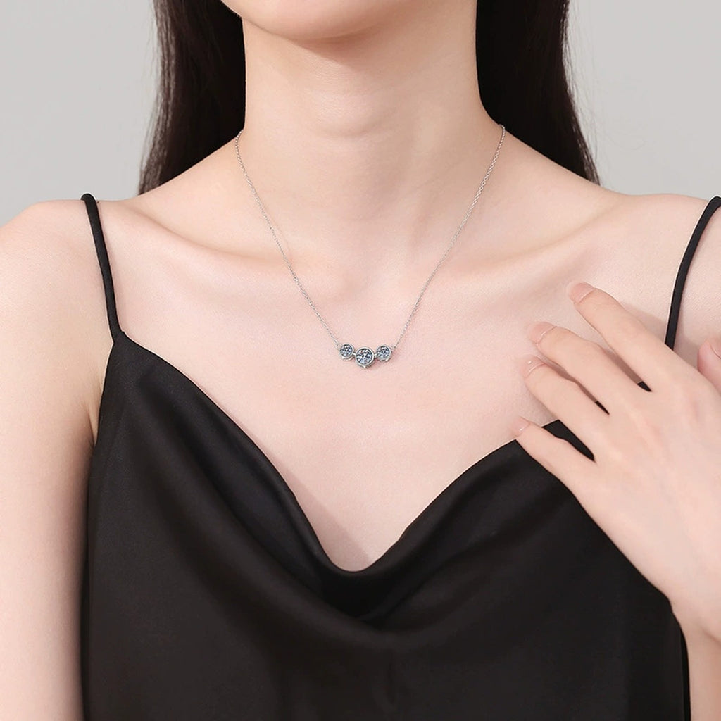 Three-Stone Moissanite Station Necklace in Platinum-Plated S925 Sterling Silver worn on neckline by model