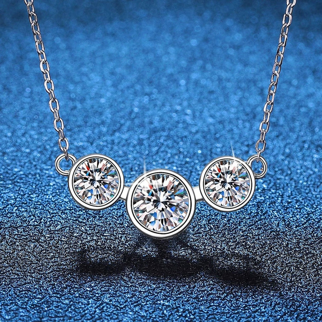 Three-Stone Moissanite Station Necklace in Platinum-Plated S925 Sterling Silver blue background close-up view