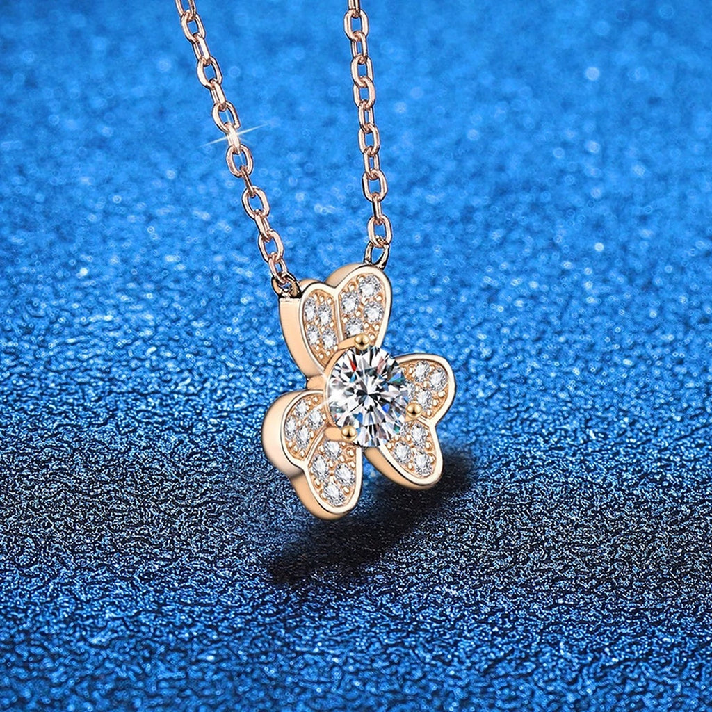 Four-Leaf Clover Moissanite Pendant Necklace in Champagne Gold-Plated S925 Sterling Silver blue background angled view
