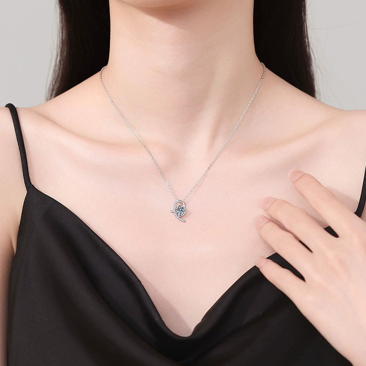 Crescent Moon Moissanite Pendant Necklace in Platinum-Plated S925 Sterling Silver worn on neckline by model