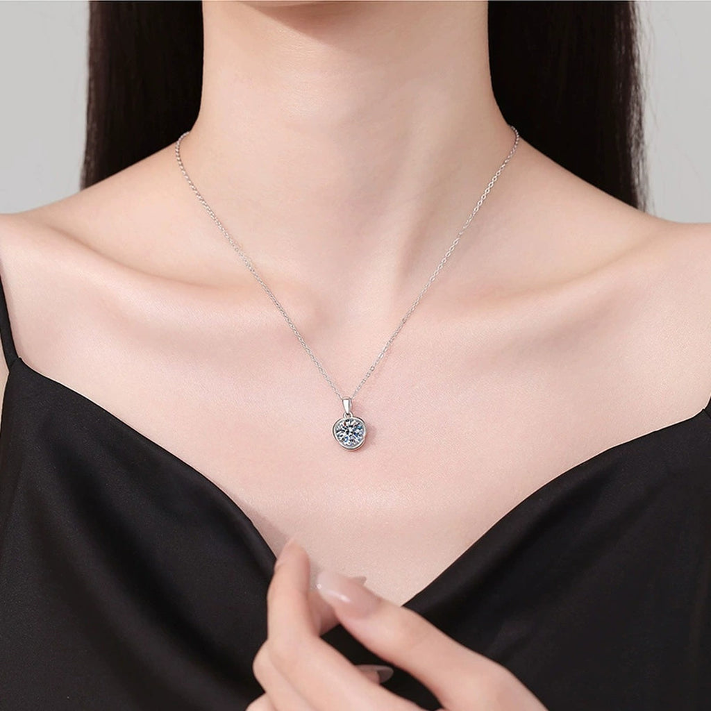 Round Bezel Moissanite Pendant Necklace in Platinum-Plated S925 Sterling Silver worn on neckline by model