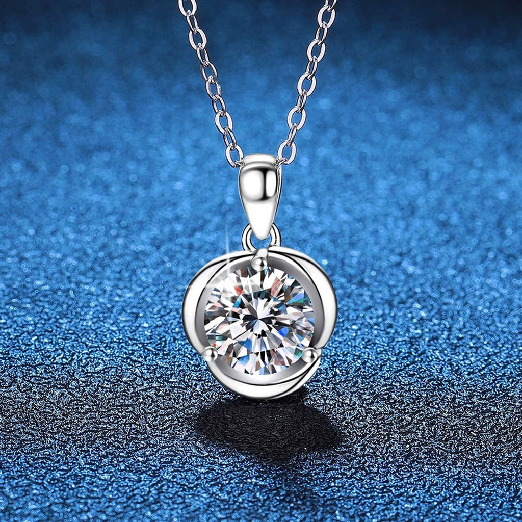 Round Bezel Moissanite Pendant Necklace in Platinum-Plated S925 Sterling Silver blue background close-up view