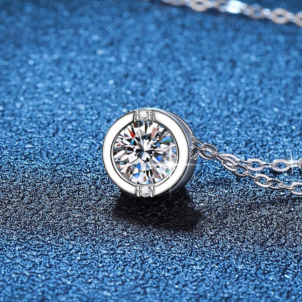 Round Solitaire Moissanite Pendant Necklace in Platinum-Plated S925 Sterling Silver blue background angled view