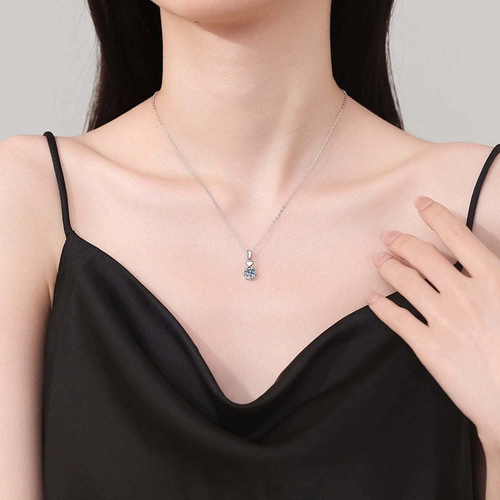 Heart Charm Moissanite Pendant Necklace in Platinum-Plated S925 Sterling Silver worn on neckline by model