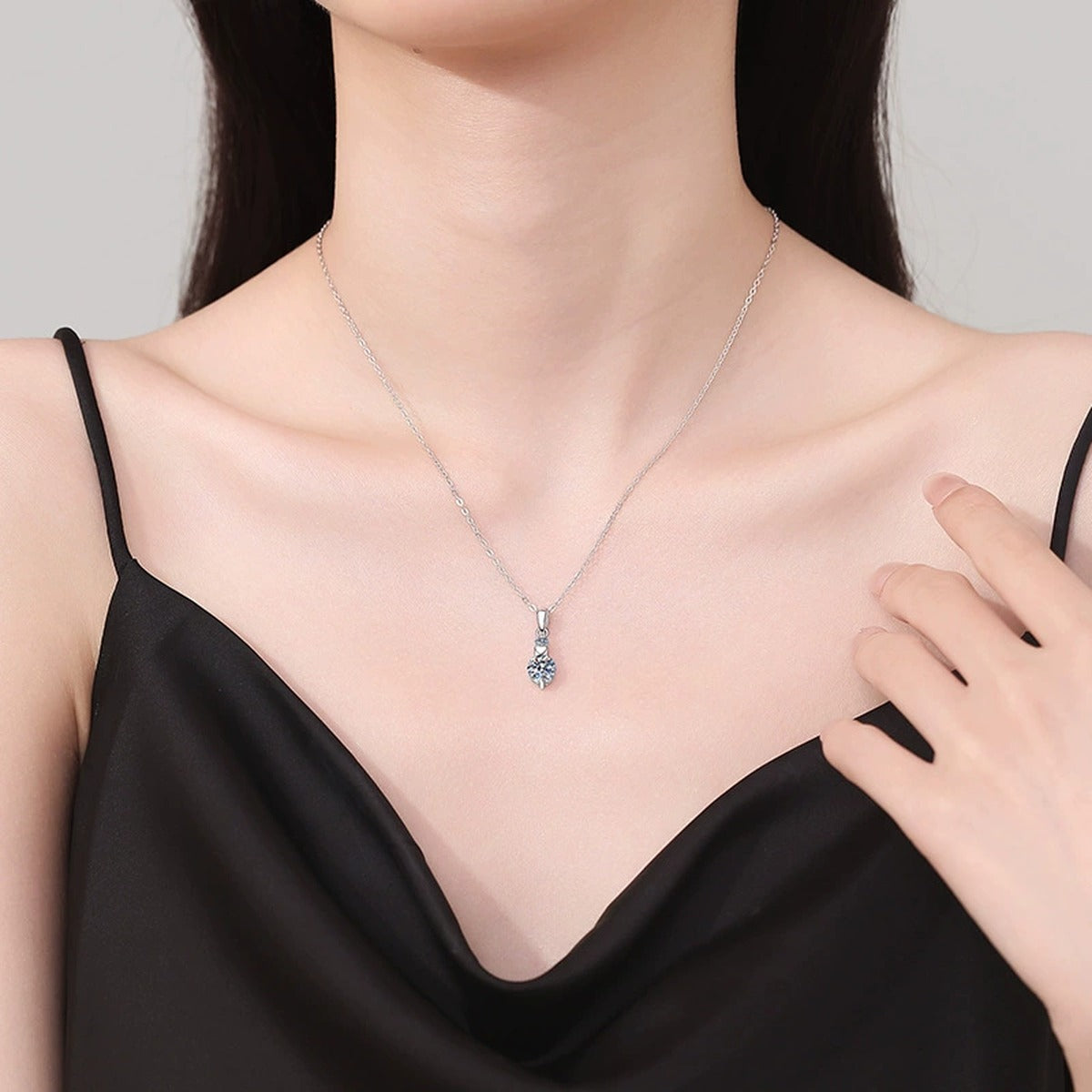 Two-Stone Drop Moissanite Pendant Necklace in Platinum-Plated S925 Sterling Silver worn on neckline by model