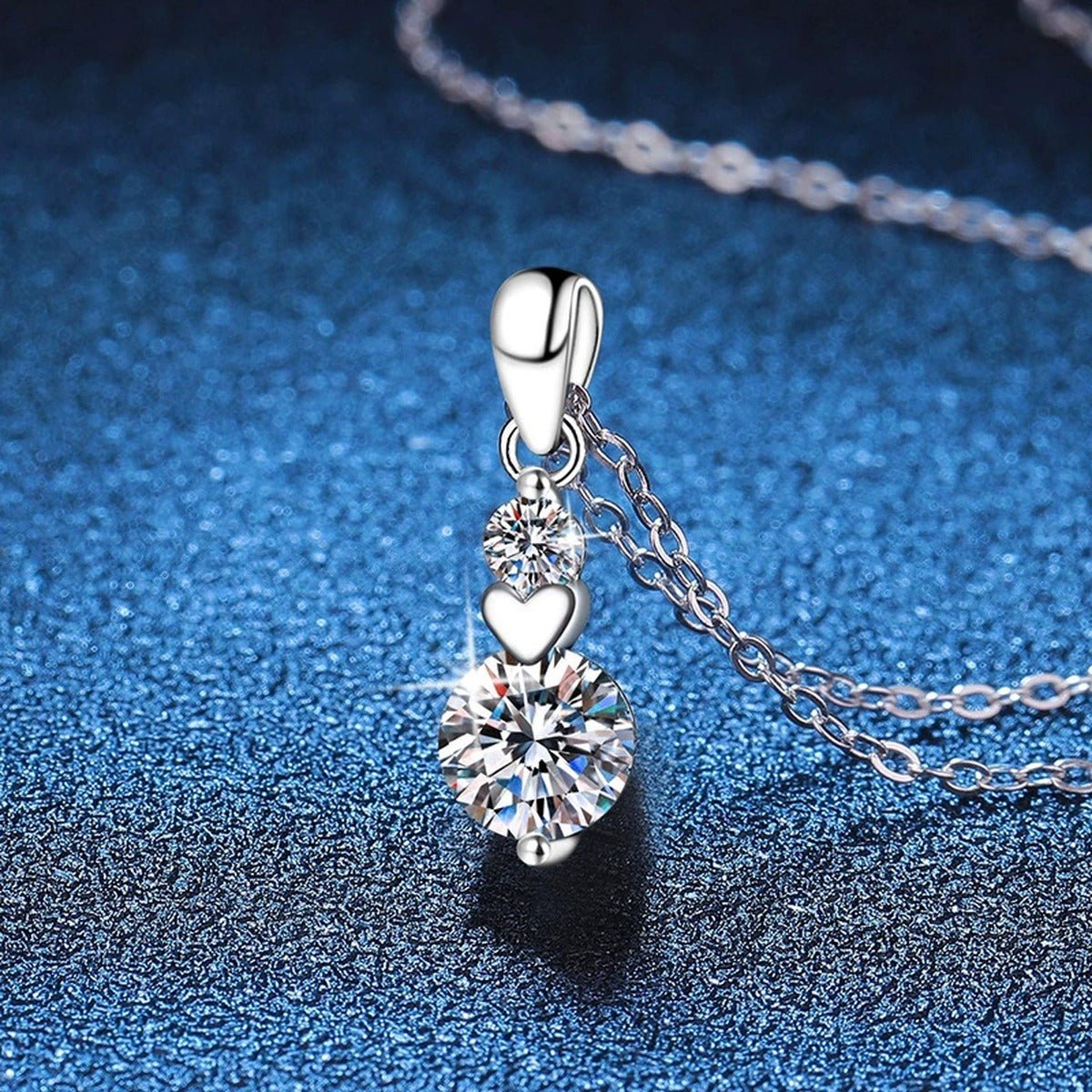 Two-Stone Drop Moissanite Pendant Necklace in Platinum-Plated S925 Sterling Silver blue background angled view