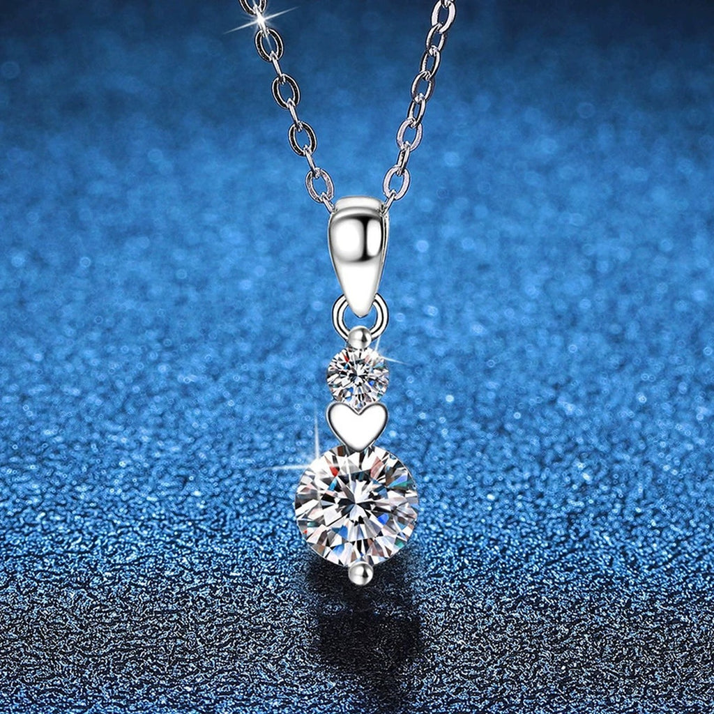 Two-Stone Drop Moissanite Pendant Necklace in Platinum-Plated S925 Sterling Silver blue background close-up view