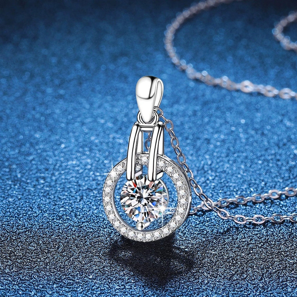 Round Halo Frame Moissanite Pendant Necklace in Platinum-Plated S925 Sterling Silver blue background close-up view