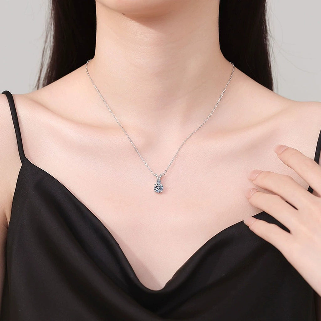 Graduated Drop Moissanite Pendant Necklace in Platinum-Plated S925 Sterling Silver worn on neckline by model