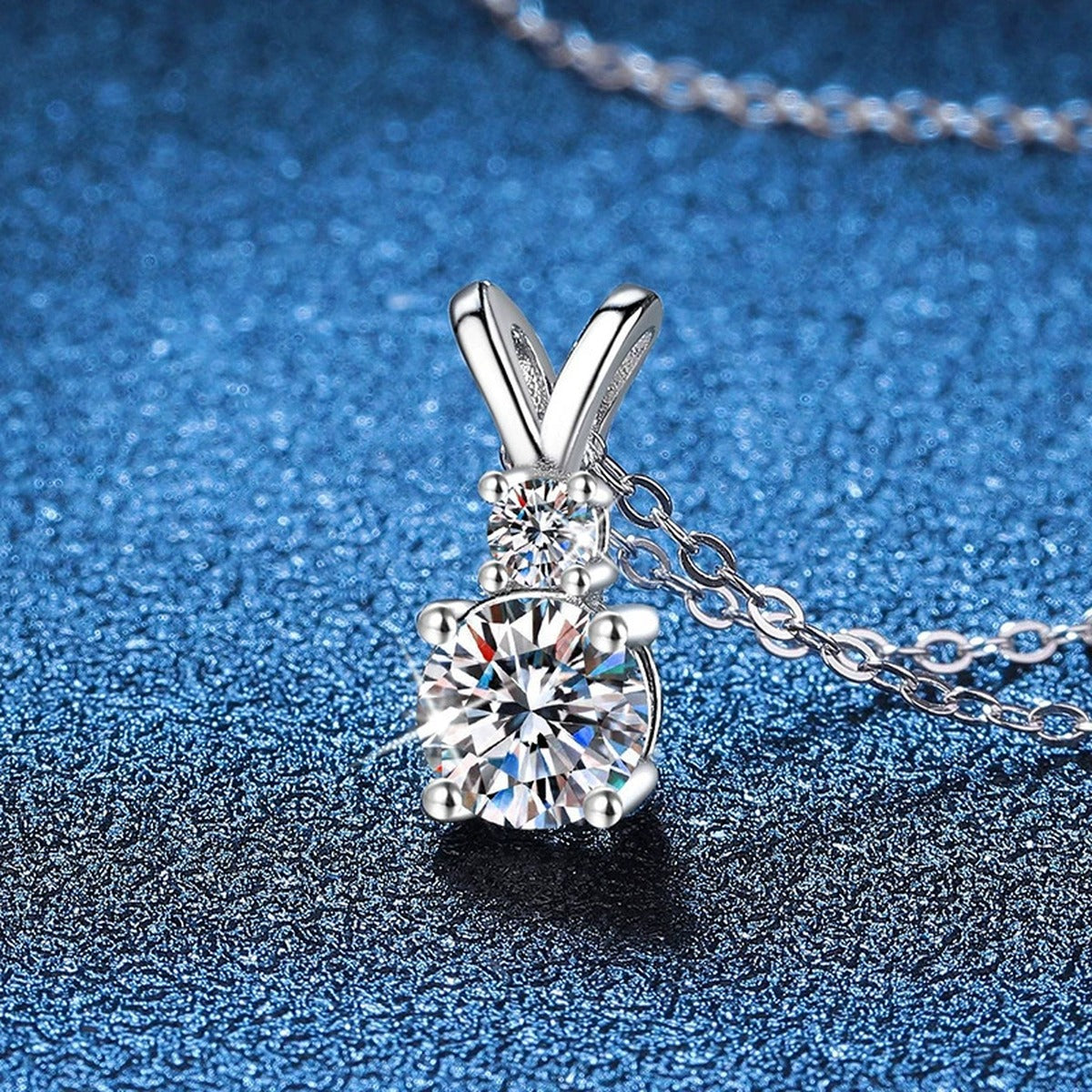Graduated Drop Moissanite Pendant Necklace in Platinum-Plated S925 Sterling Silver blue background product view