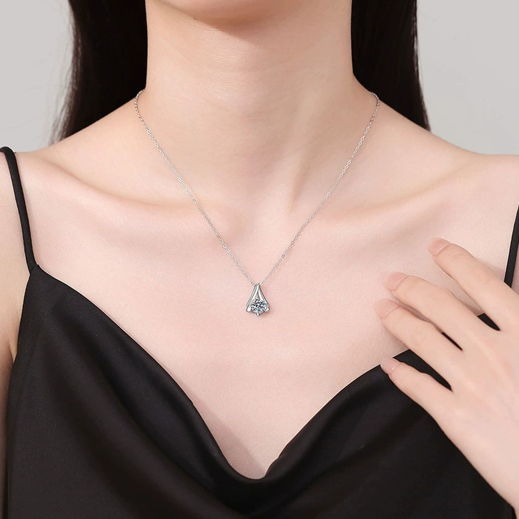 Teardrop Solitaire Moissanite Pendant Necklace in Platinum-Plated S925 Sterling Silver worn on neckline by model