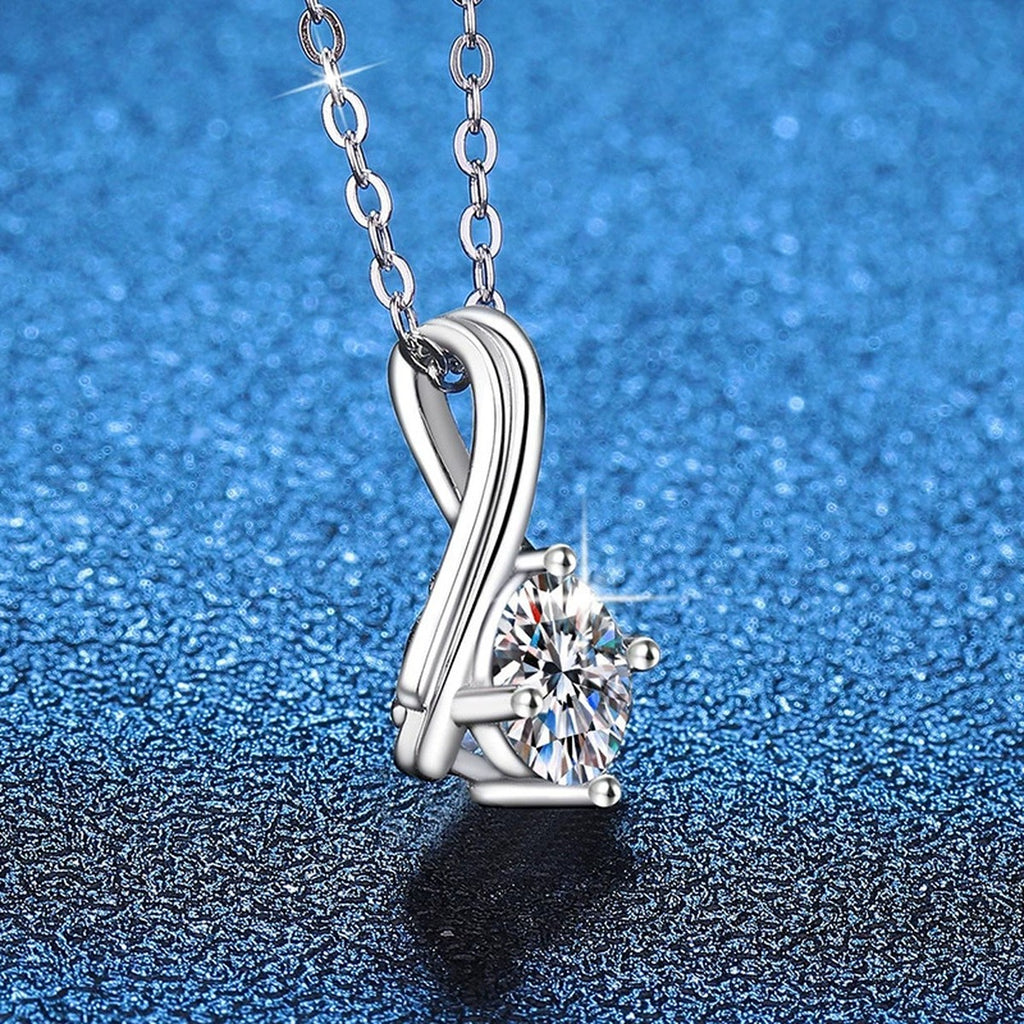 Teardrop Solitaire Moissanite Pendant Necklace in Platinum-Plated S925 Sterling Silver blue background angled view