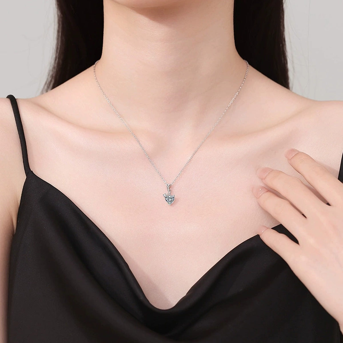 Heart Twist Moissanite Pendant Necklace in Platinum-Plated S925 Sterling Silver worn on neckline by model