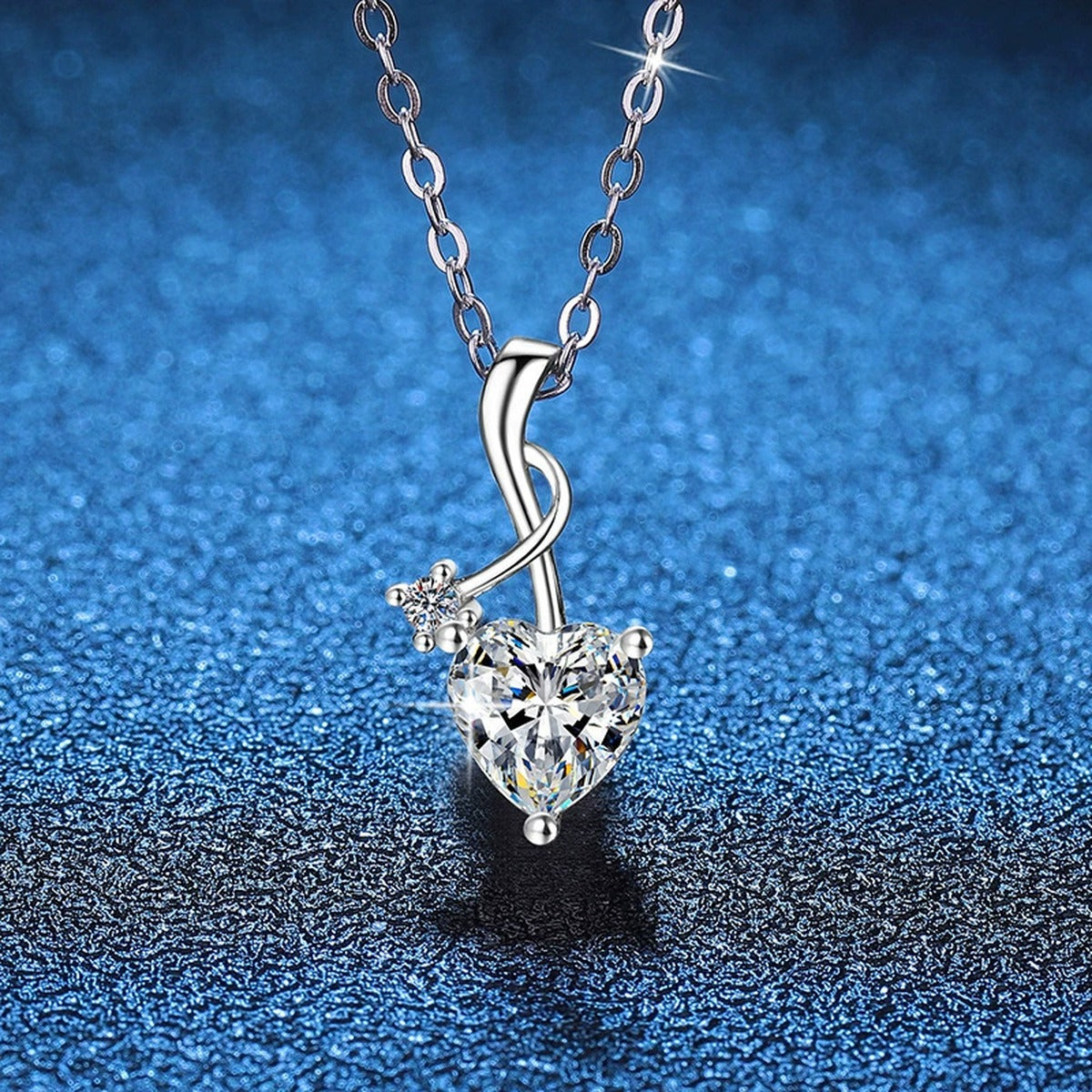 Heart Twist Moissanite Pendant Necklace in Platinum-Plated S925 Sterling Silver blue background close-up view