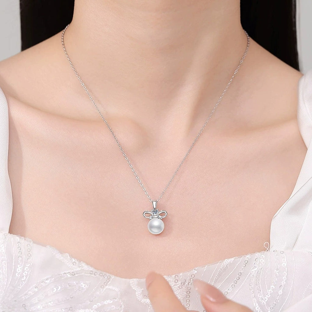 Bow Moissanite Freshwater Pearl Pendant Necklace with Cubic Zirconia in White Gold-Plated S925 Sterling Silver worn on neckline by model