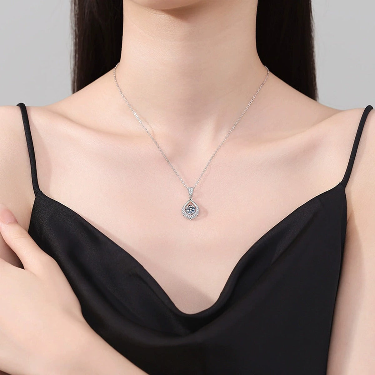 Teardrop Halo Moissanite Pendant Necklace in Platinum-Plated S925 Sterling Silver worn on neckline by model
