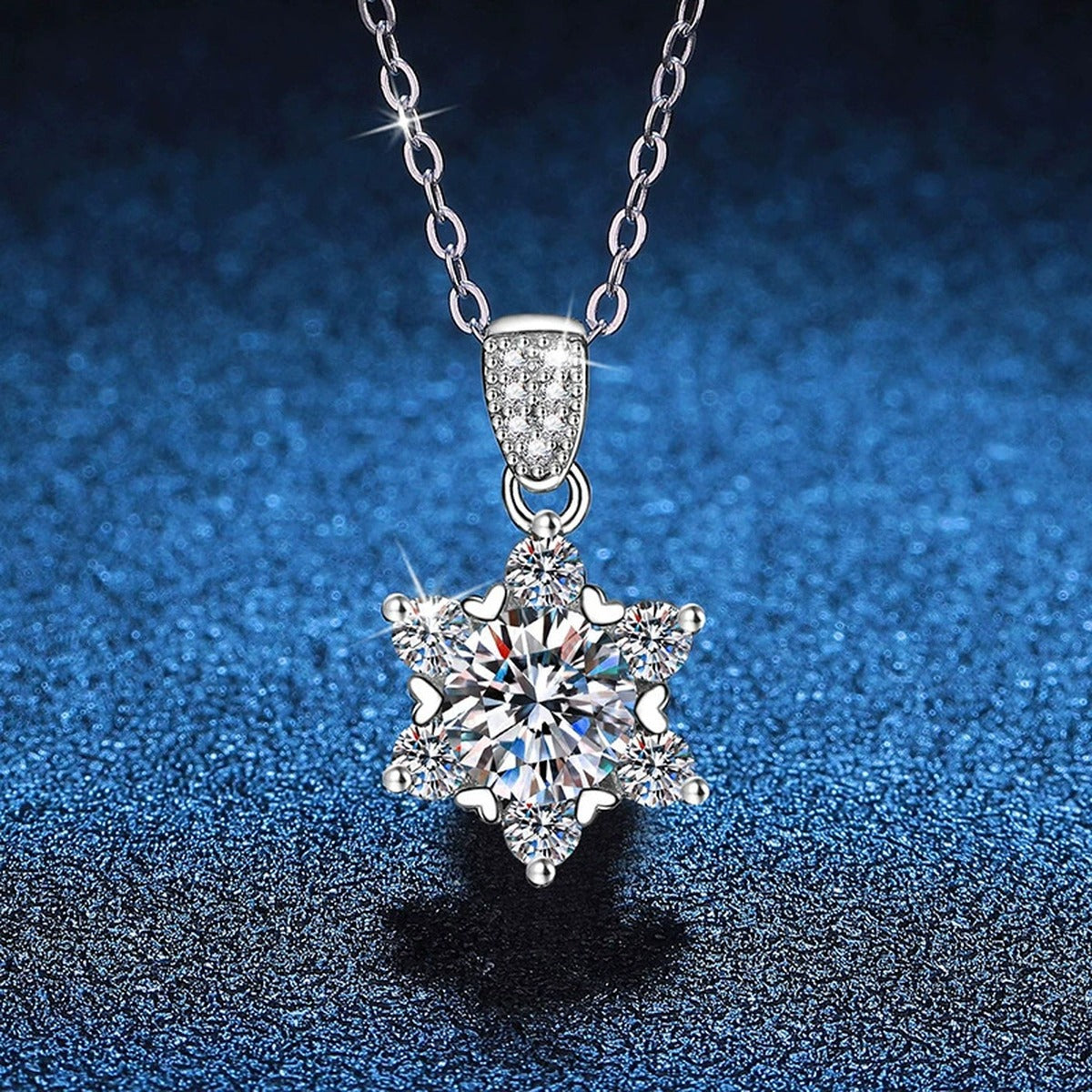 Floral Star Halo Moissanite Pendant Necklace in Platinum-Plated S925 Sterling Silver blue background angled view