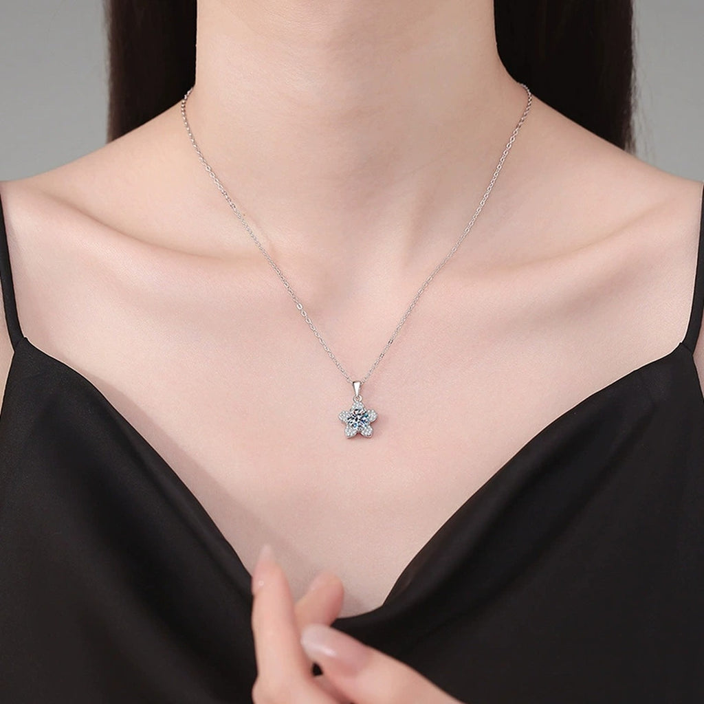 Five-Petal Flower Moissanite Pendant Necklace in Platinum-Plated S925 Sterling Silver worn on neckline by model