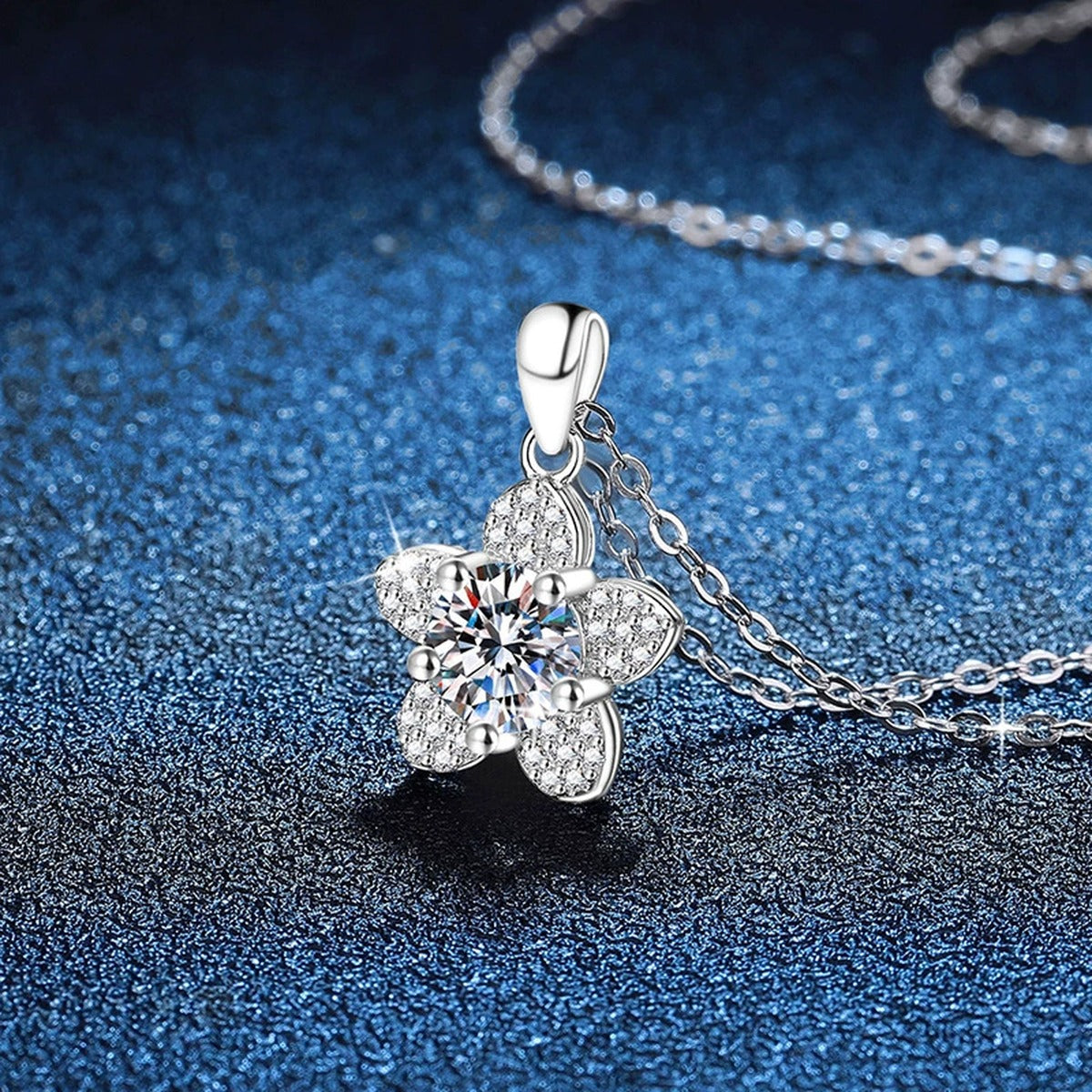 Five-Petal Flower Moissanite Pendant Necklace in Platinum-Plated S925 Sterling Silver blue background angled view