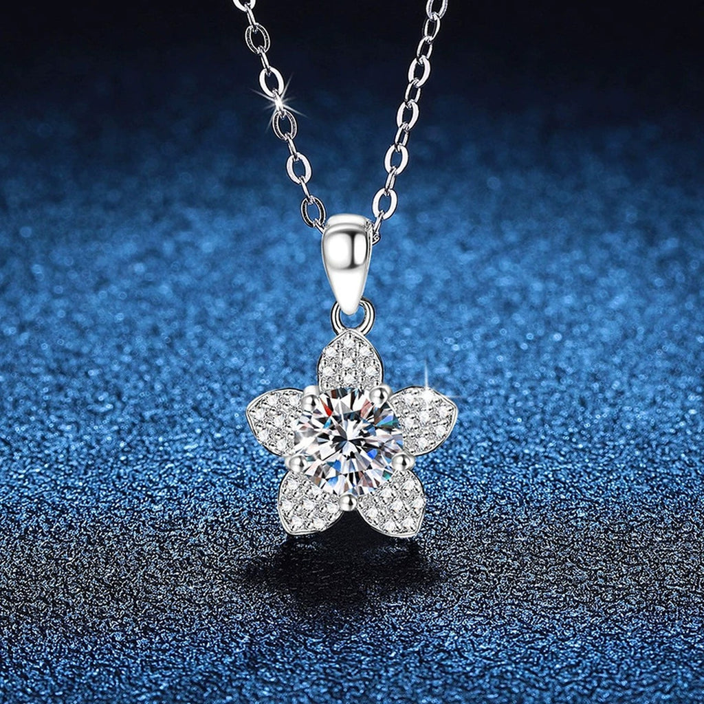 Five-Petal Flower Moissanite Pendant Necklace in Platinum-Plated S925 Sterling Silver blue background close-up view