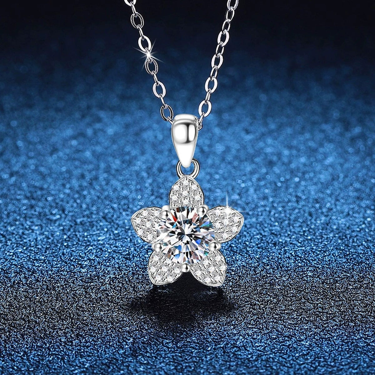 Five-Petal Flower Moissanite Pendant Necklace in Platinum-Plated S925 Sterling Silver blue background close-up view