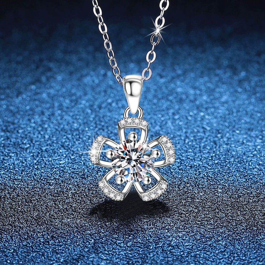 Bow Flower Moissanite Pendant Necklace in Platinum-Plated S925 Sterling Silver blue background close-up view