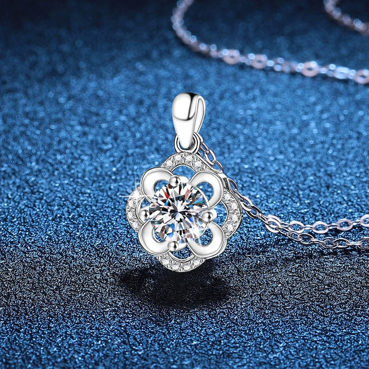 Camellia Flower Moissanite Pendant Necklace in Platinum-Plated S925 Sterling Silver blue background angled view