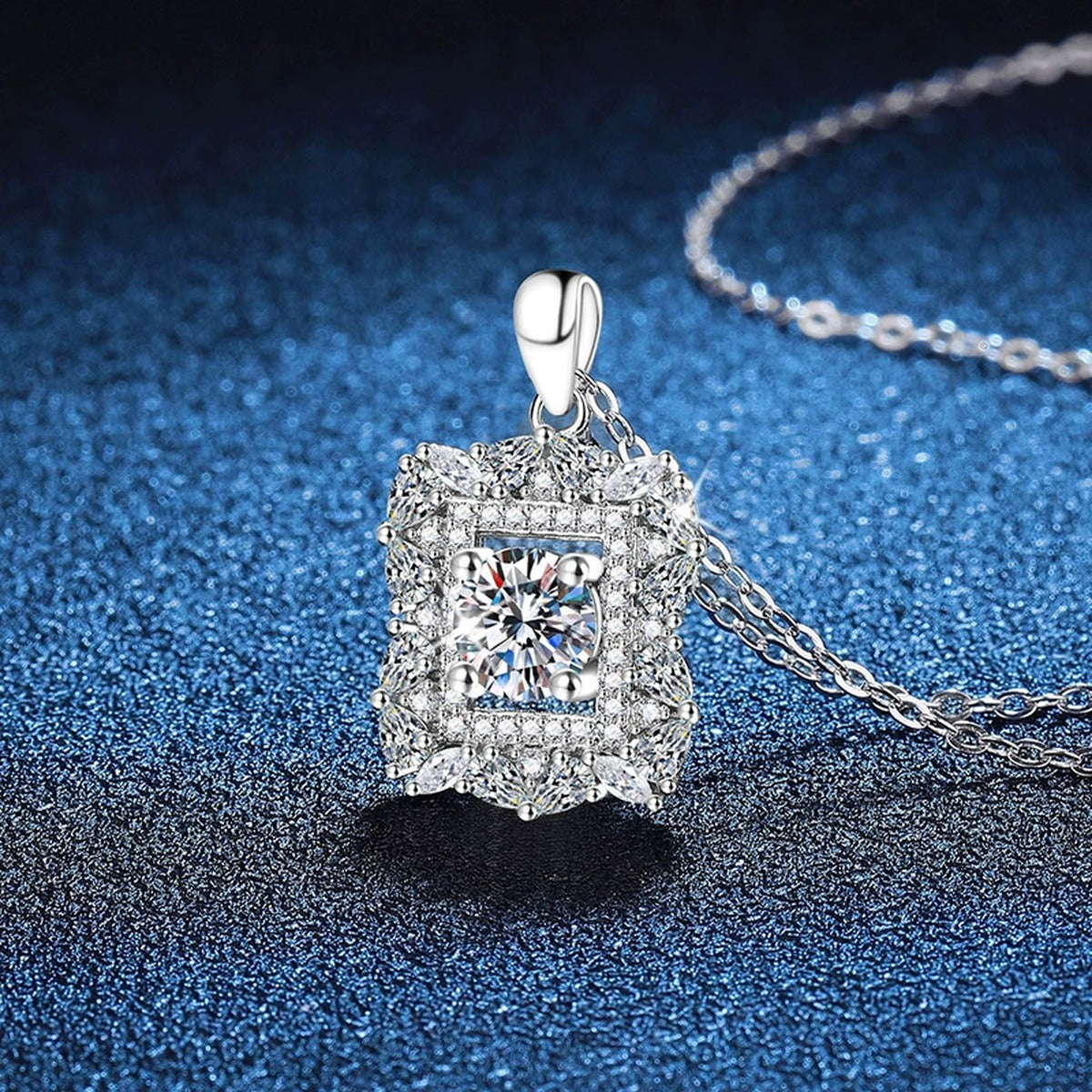 Square Halo Moissanite Pendant Necklace in Platinum-Plated S925 Sterling Silver blue background angled view