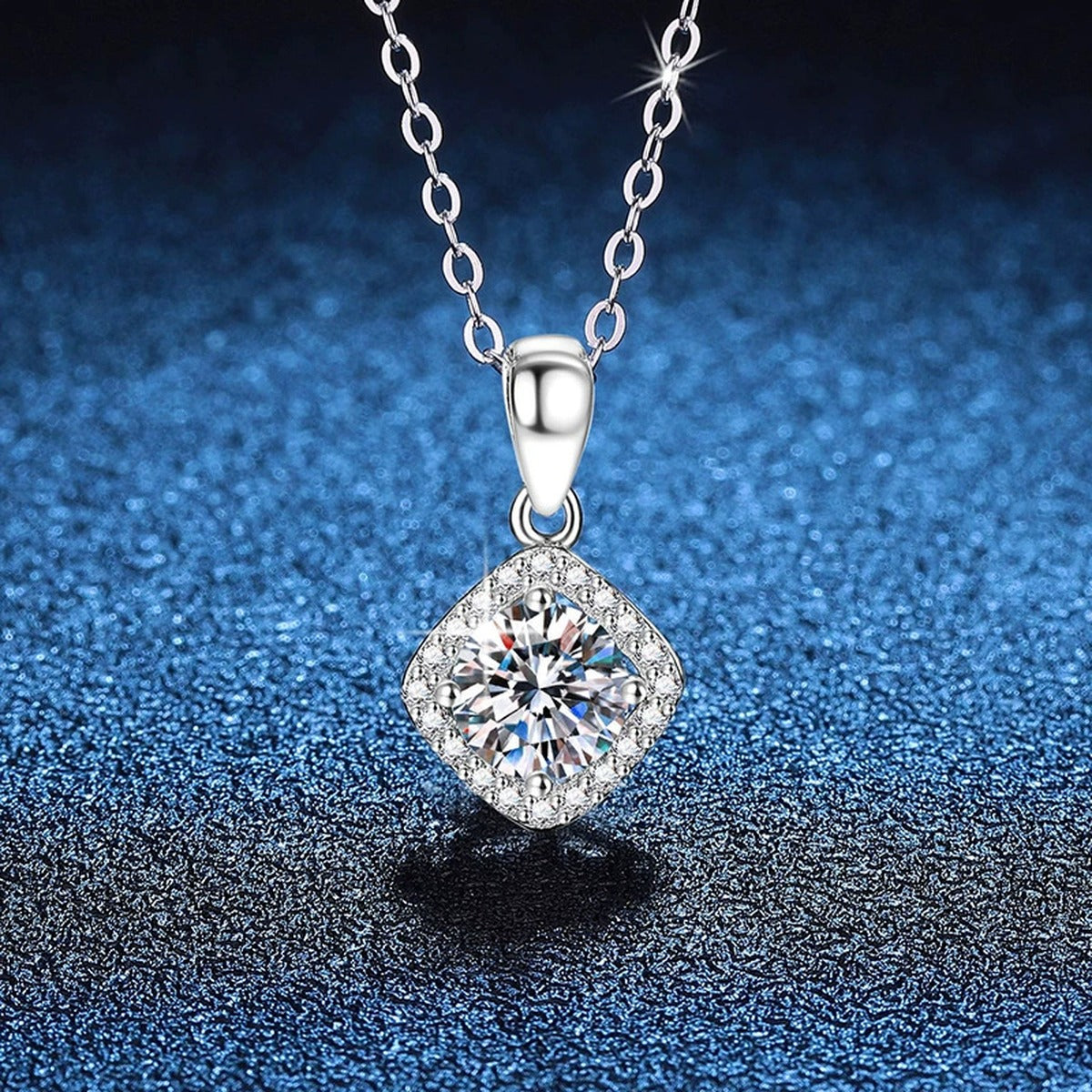 Kite Halo Moissanite Pendant Necklace in Platinum-Plated S925 Sterling Silver blue background angled view