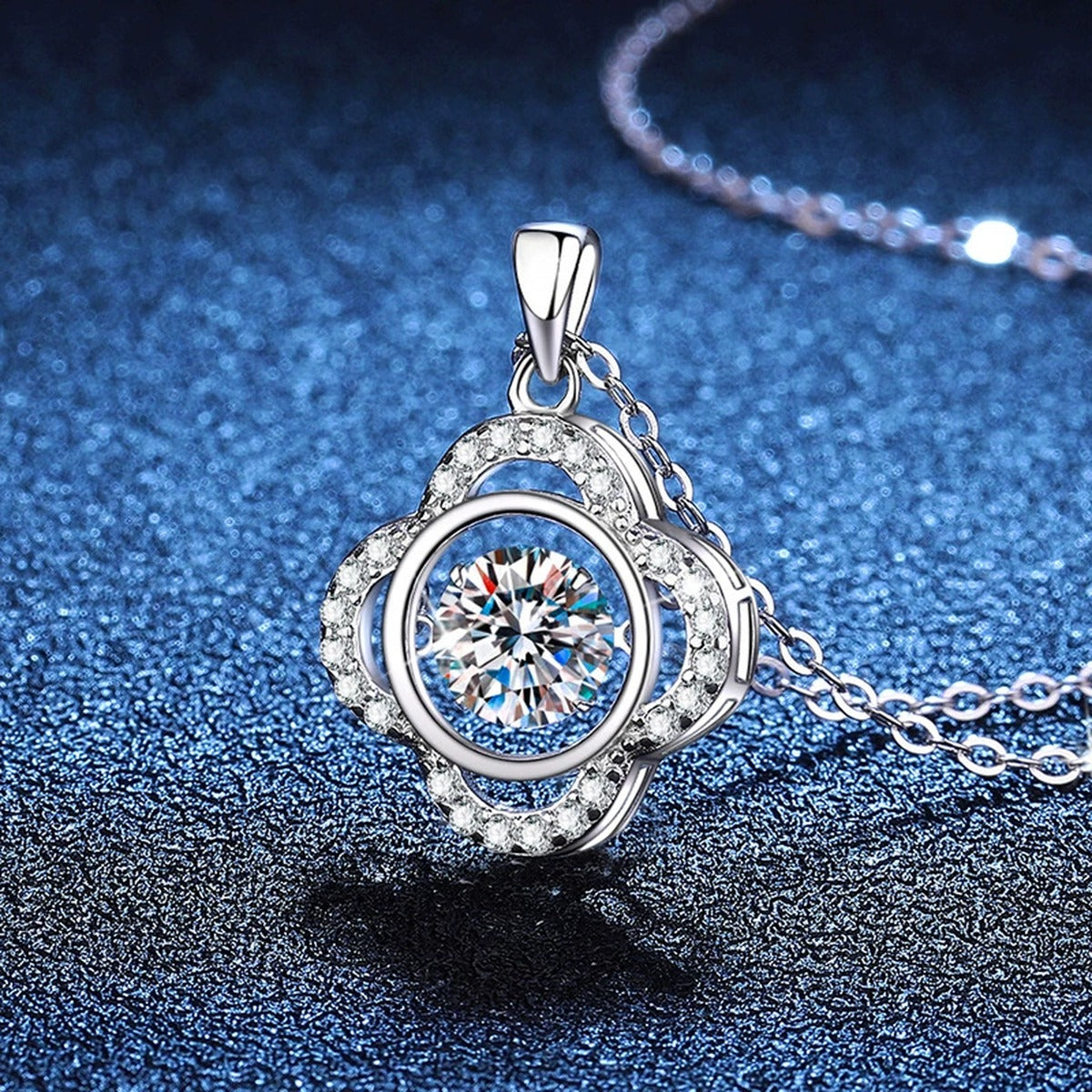 Quatrefoil Halo Moissanite Pendant Necklace in Platinum-Plated S925 Sterling Silver blue background angled view