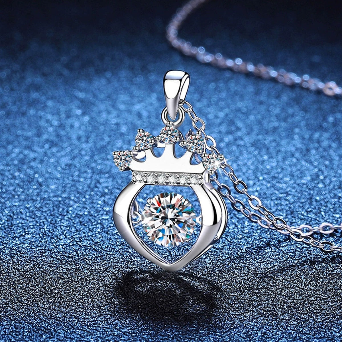 Crown Heart Moissanite Pendant Necklace in Platinum-Plated S925 Sterling Silver blue background angled view