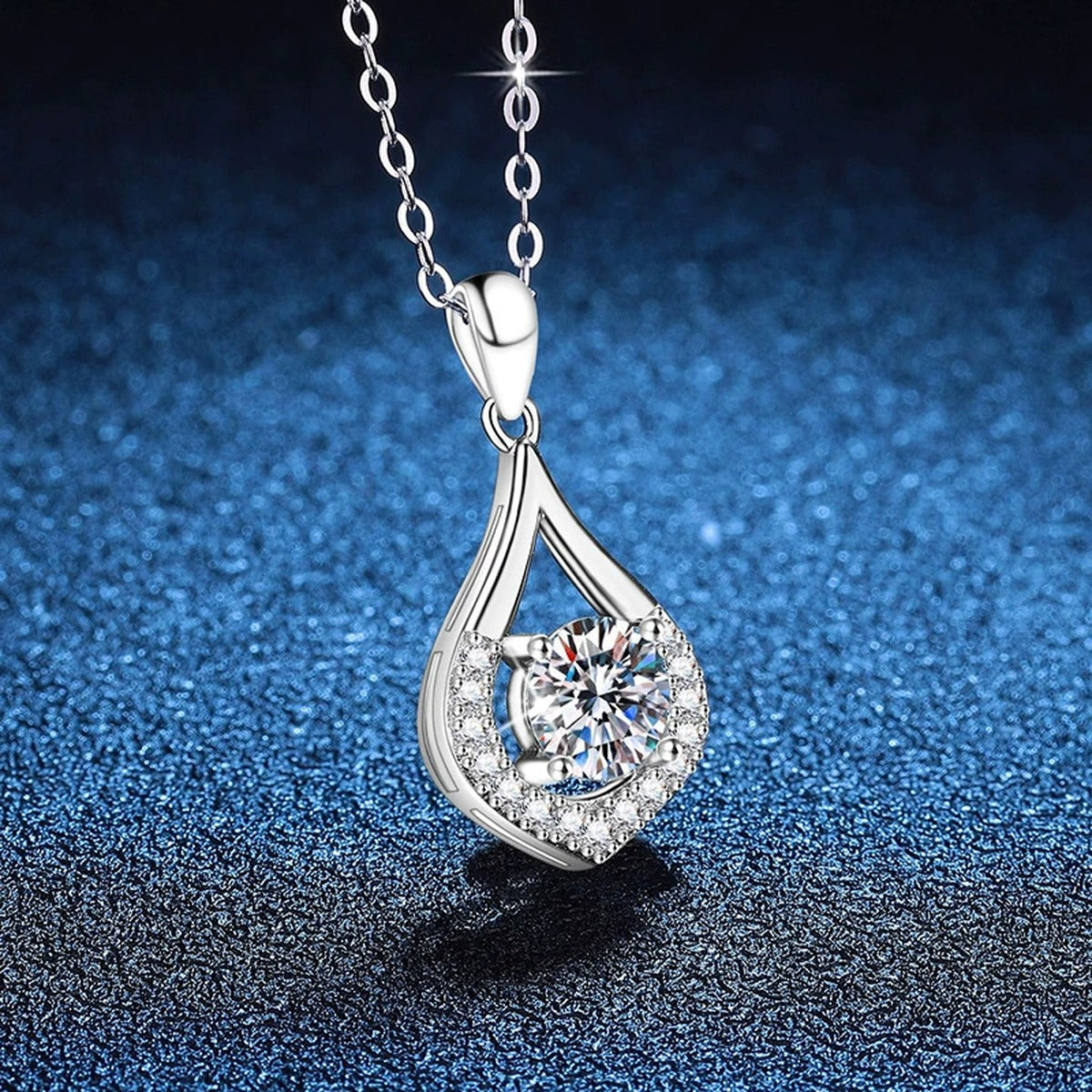 Teardrop Halo Moissanite Pendant Necklace in Platinum-Plated S925 Sterling Silver blue background angled view