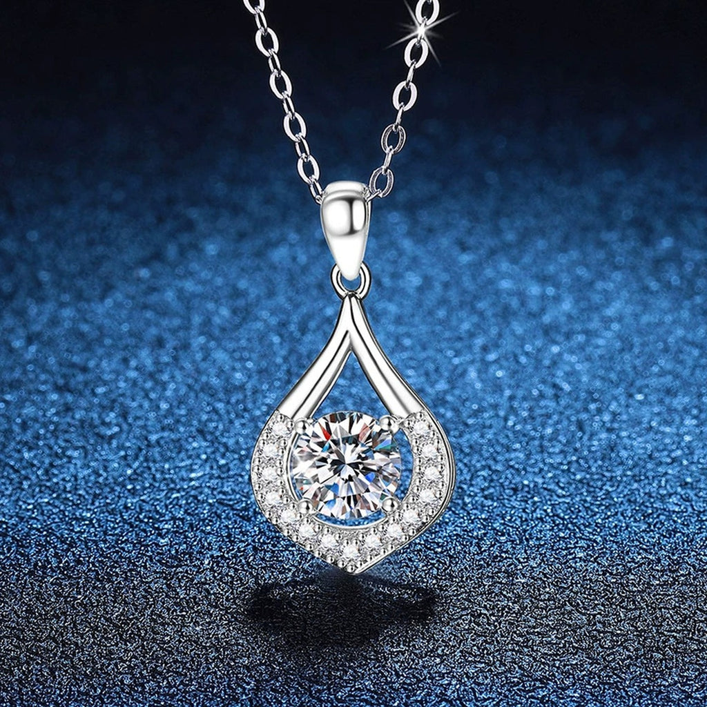 Teardrop Halo Moissanite Pendant Necklace in Platinum-Plated S925 Sterling Silver blue background close-up view