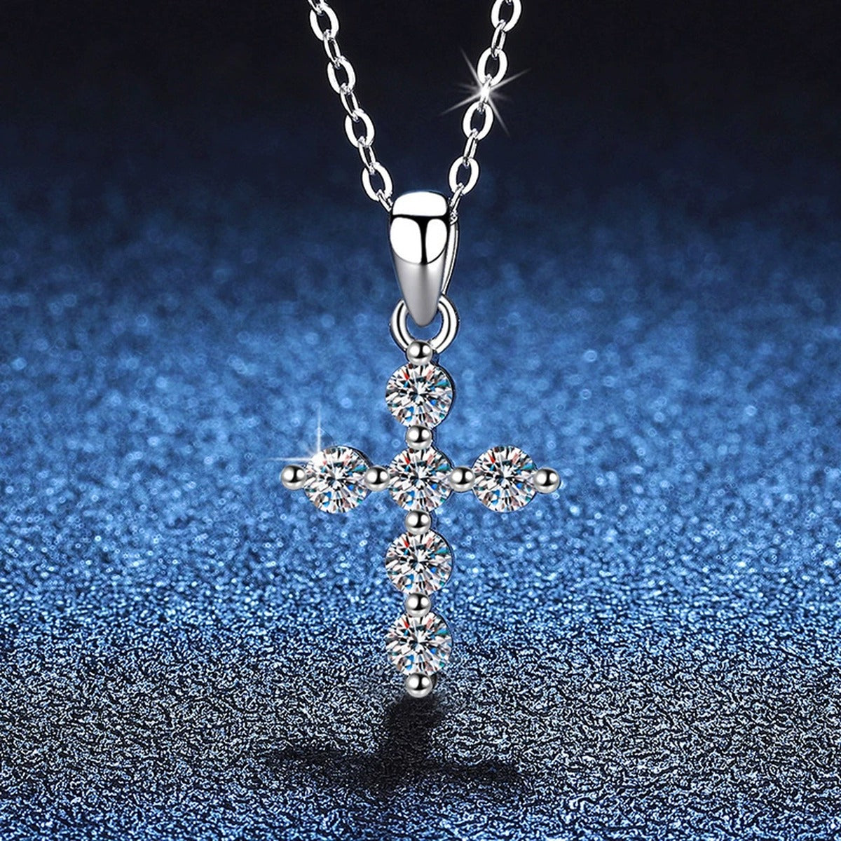 Multi-Stone Cross Moissanite Pendant Necklace in Platinum-Plated S925 Sterling Silver blue background close-up view