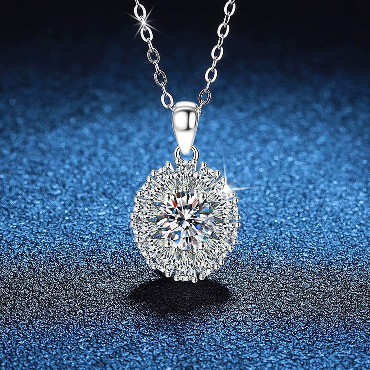 Sunburst Halo Moissanite Pendant Necklace in Platinum-Plated S925 Sterling Silver blue background angled view