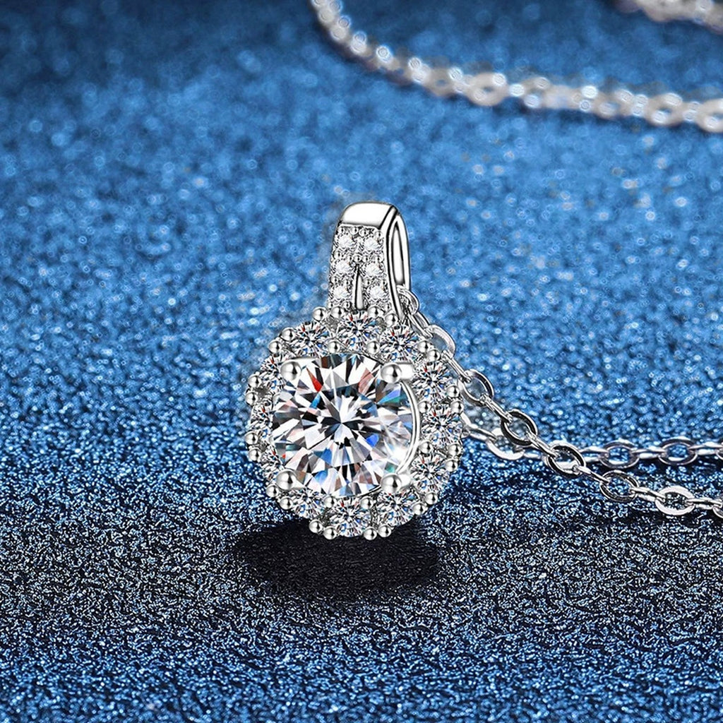 Round Halo Moissanite Pendant Necklace in Platinum-Plated S925 Sterling Silver blue background angled view