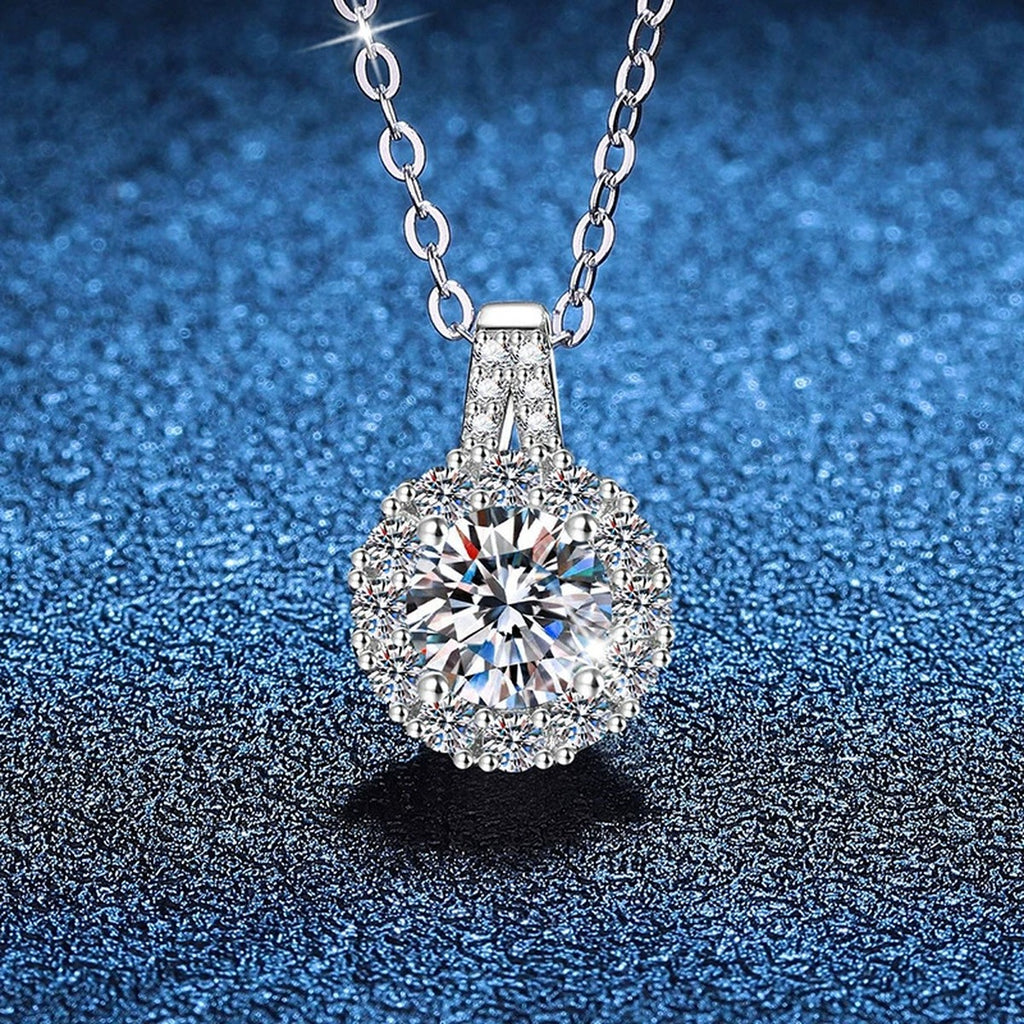 Round Halo Moissanite Pendant Necklace in Platinum-Plated S925 Sterling Silver blue background close-up view