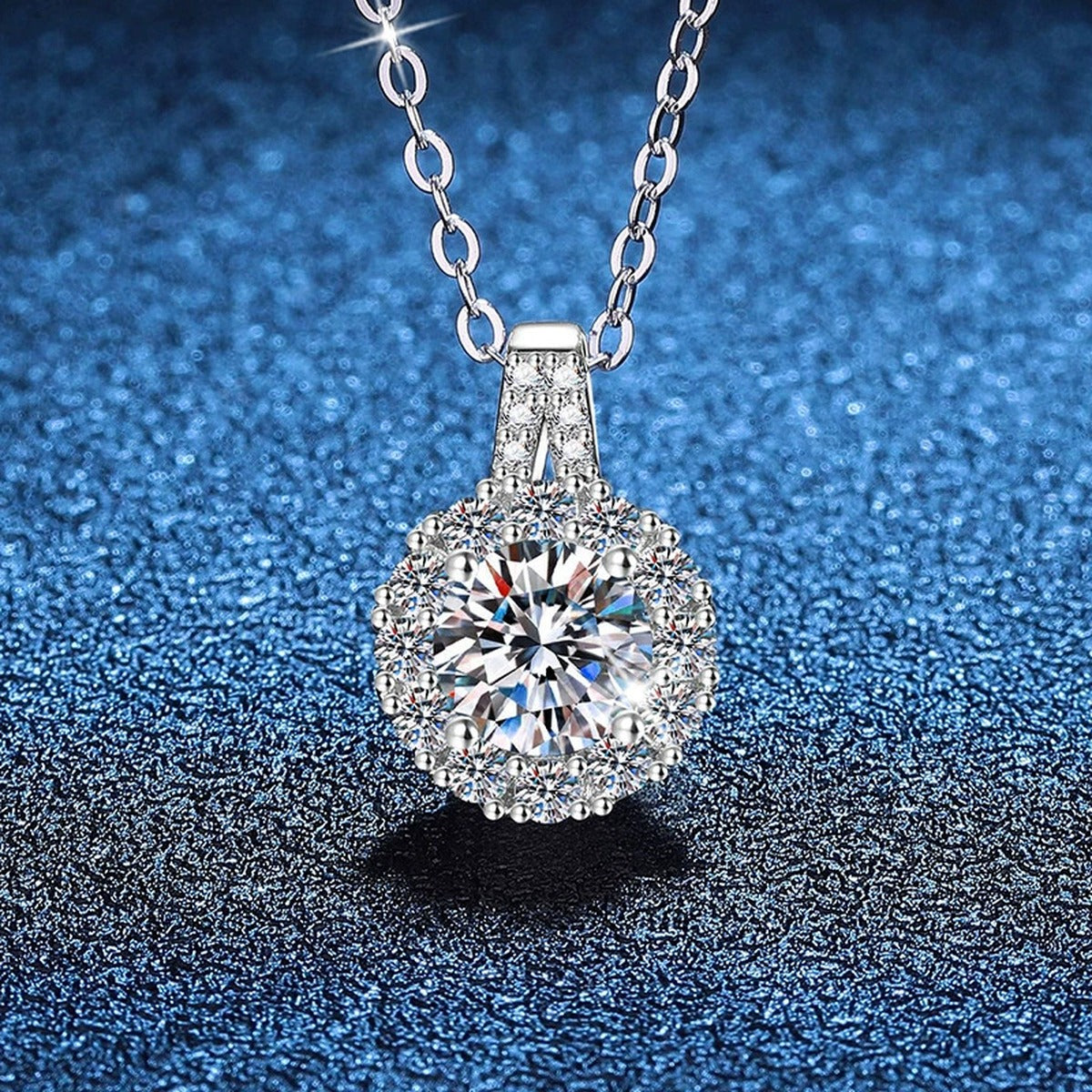 Round Halo Moissanite Pendant Necklace in Platinum-Plated S925 Sterling Silver blue background close-up view