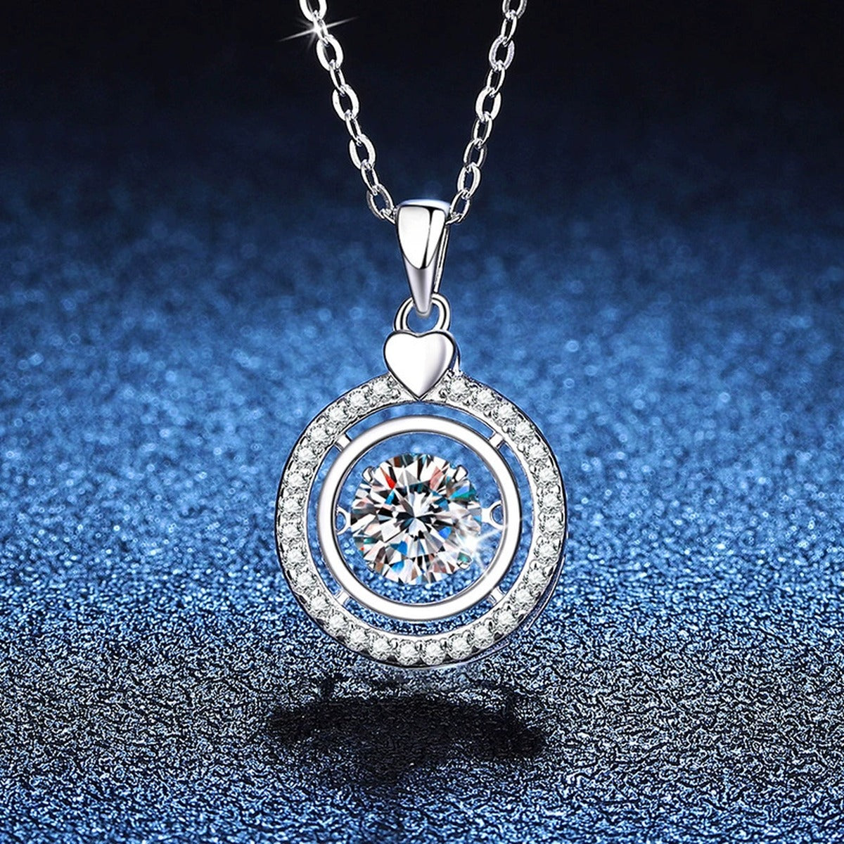 Heart Charm Round Halo Moissanite Pendant Necklace in Platinum-Plated S925 Sterling Silver blue background close-up view