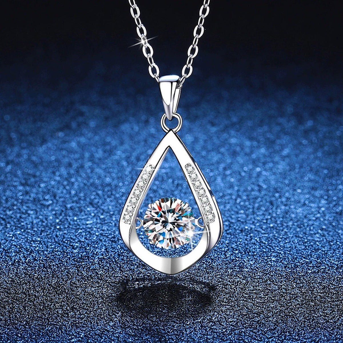 Teardrop Halo Moissanite Pendant Necklace in Platinum-Plated S925 Sterling Silver blue background angled view