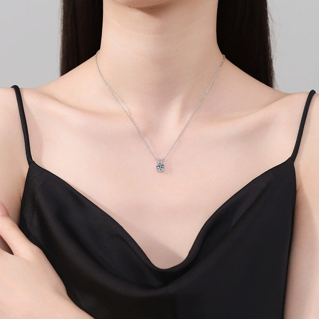 Classic Round Moissanite Solitaire Pendant Necklace in Platinum-Plated S925 Sterling Silver worn on neckline by model