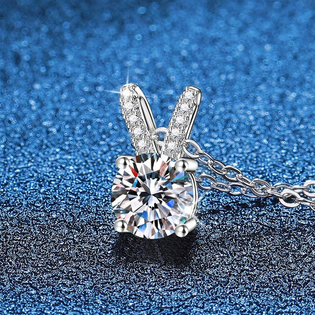 Classic Round Moissanite Solitaire Pendant Necklace in Platinum-Plated S925 Sterling Silver blue background angled view