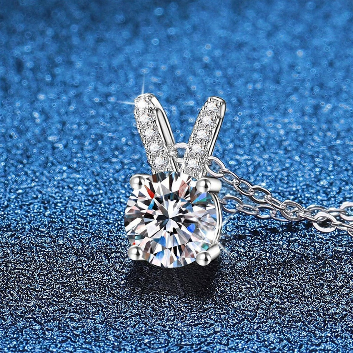 Classic Round Moissanite Solitaire Pendant Necklace in Platinum-Plated S925 Sterling Silver blue background angled view
